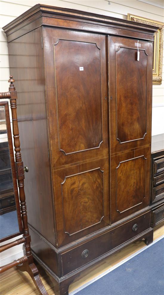 A mahogany wardrobe enclosed by a pair of doors W.112cm